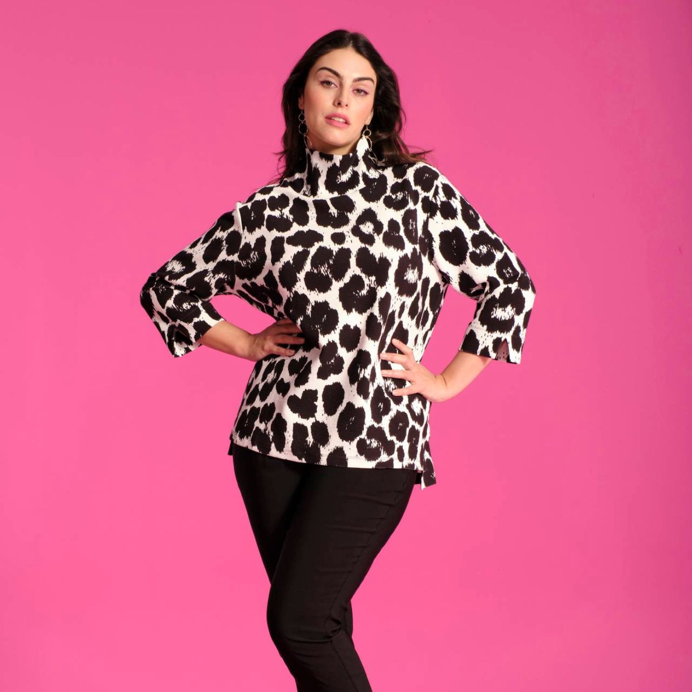 A woman wearing an Ulla Popken leopard print top