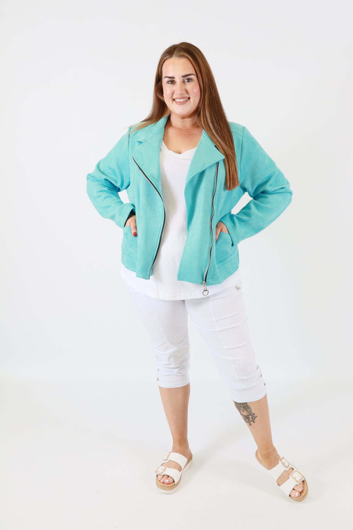 Woman wearing a turquoise jacket on a white background