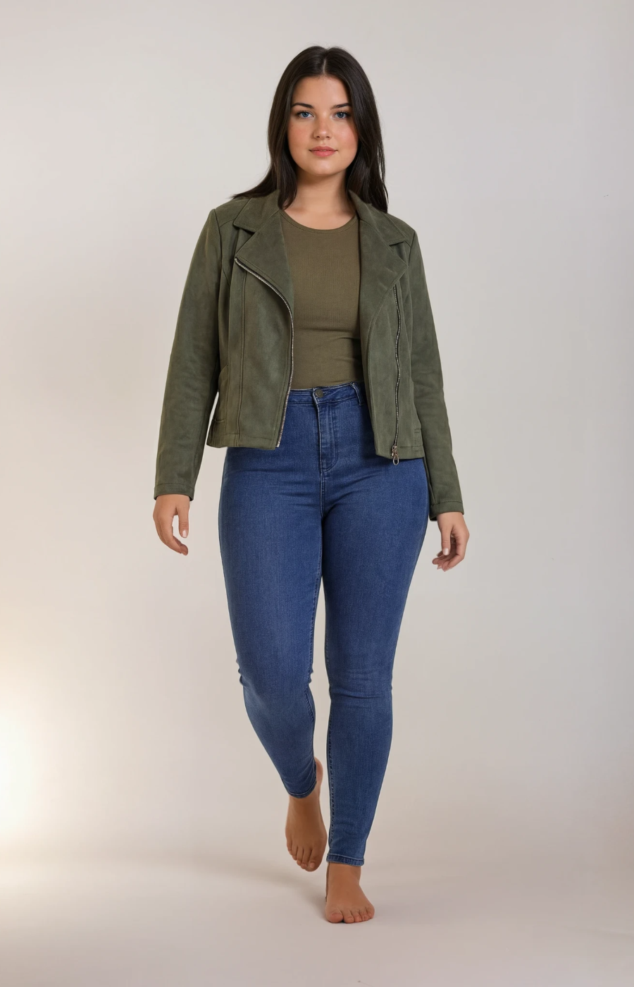 Woman wearing a green jacket and blue jeans on a white background