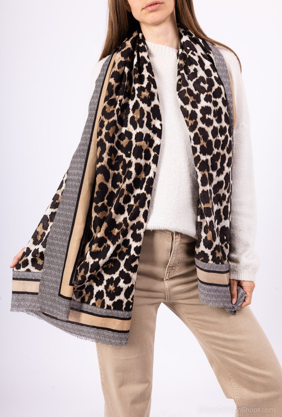 Person wearing a leopard print scarf with a white background