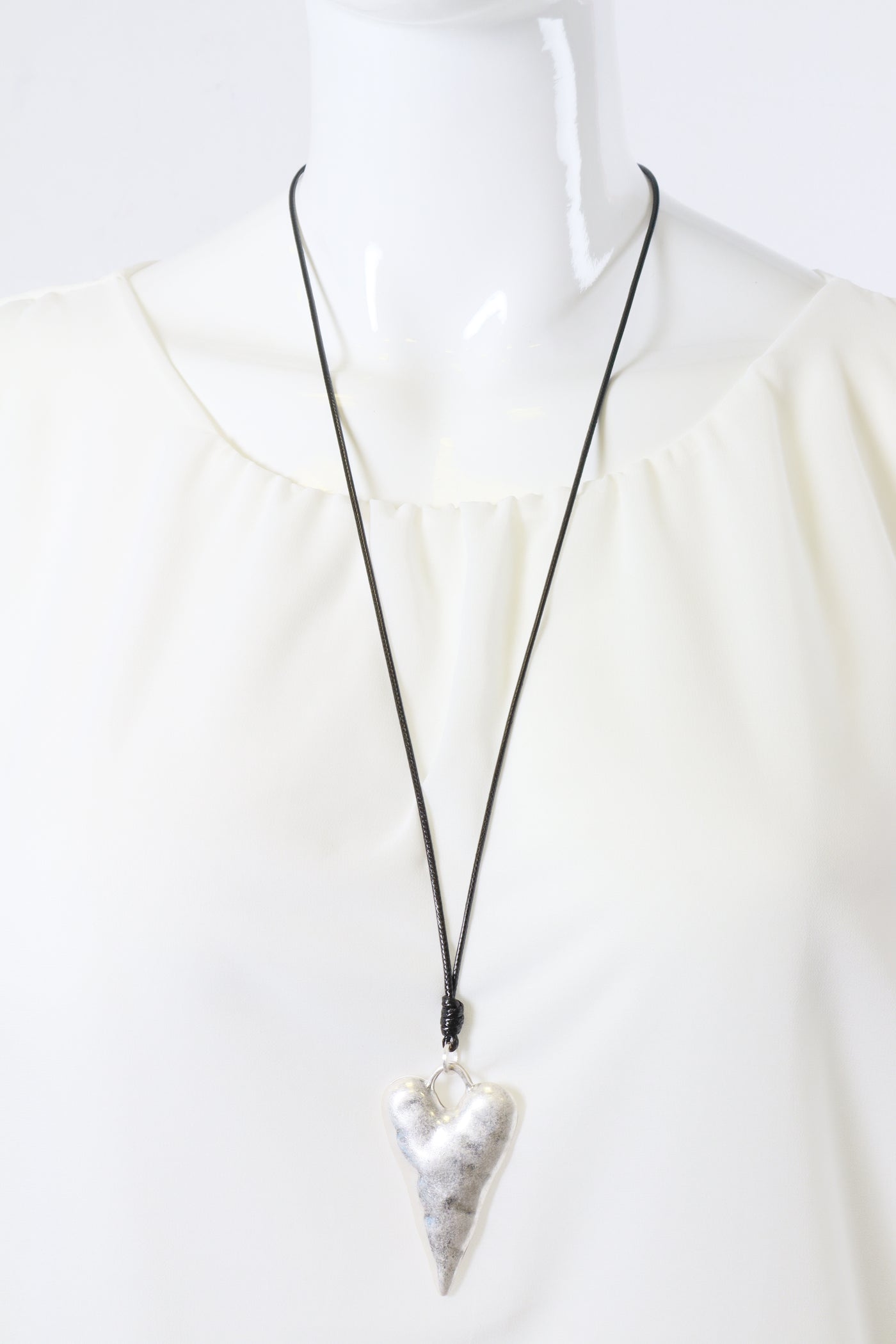 Necklace with a silver heart pendant on a white background