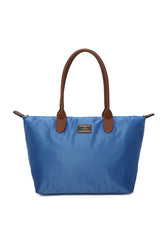 Blue tote bag with brown handles on a white background