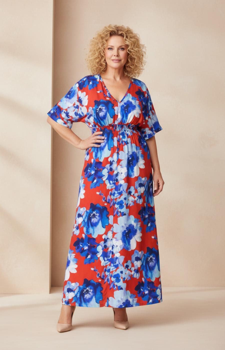 Woman wearing a floral dress with brown, blue, and white flowers on a beige background