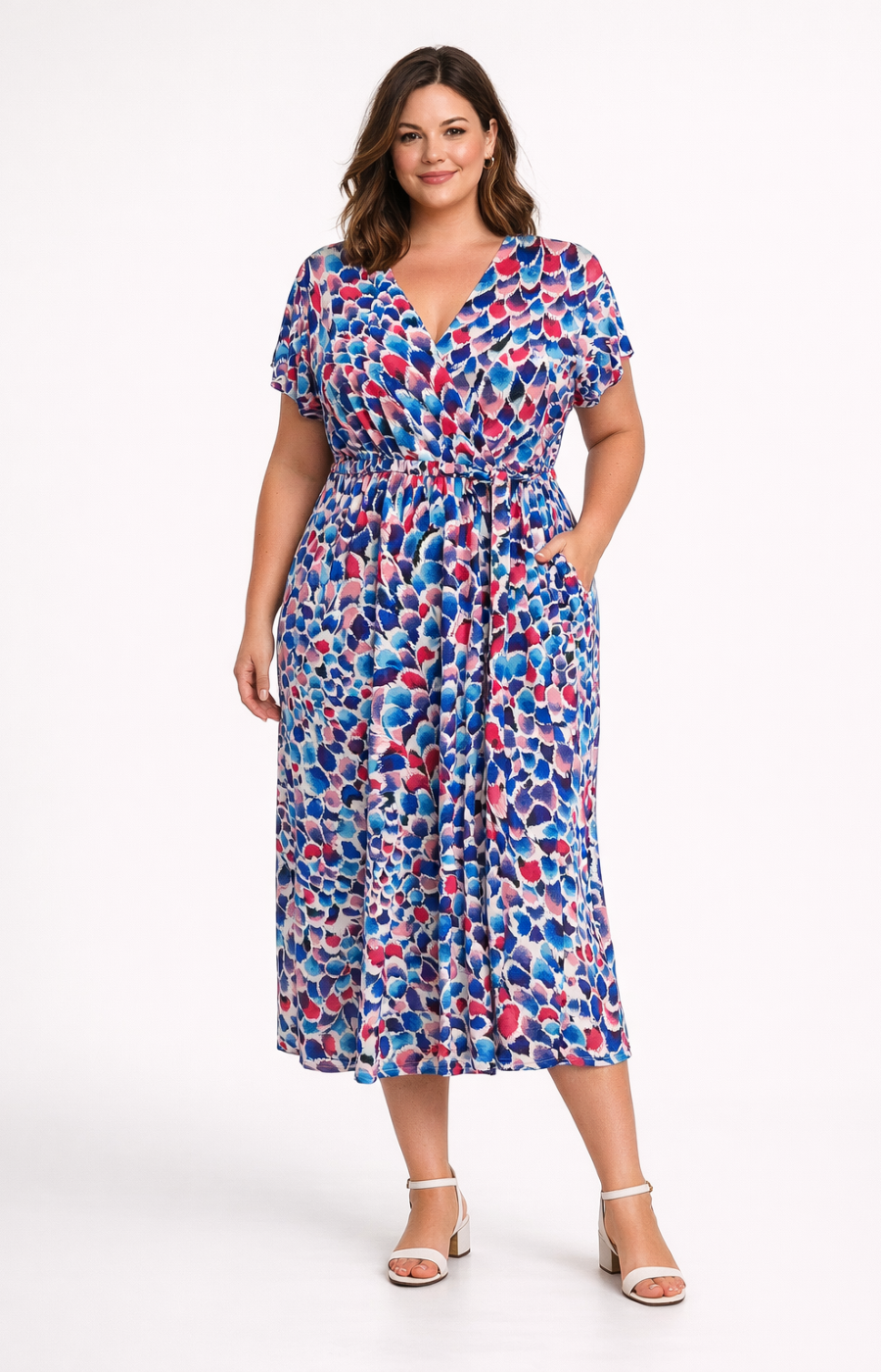 Woman wearing a colorful patterned dress on a white background