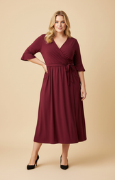 Woman wearing a burgundy wrap dress on a beige background