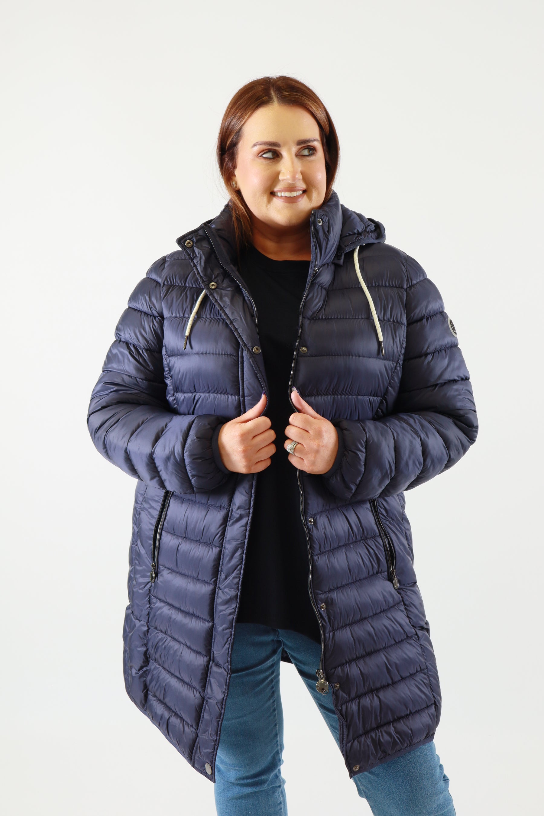 Person wearing a blue puffer coat on a white background