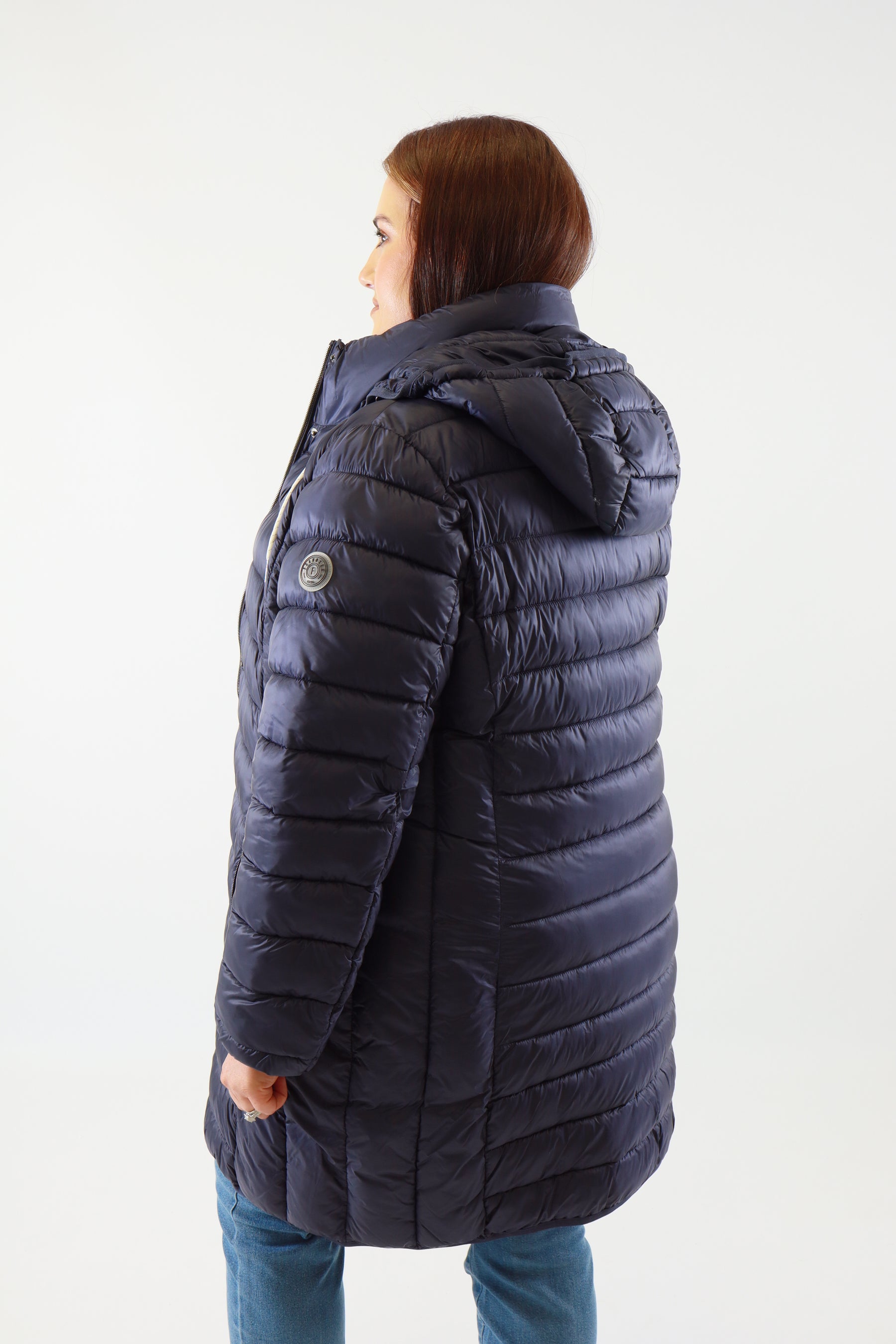 Person wearing a blue puffer jacket on a white background