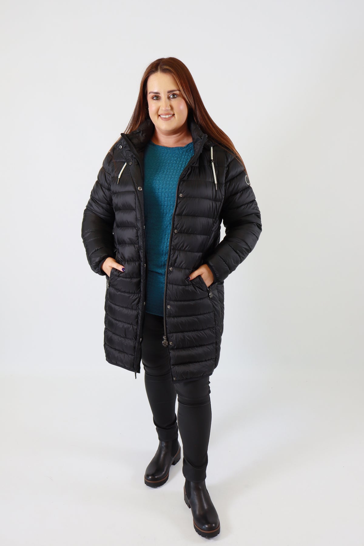 Person wearing a black coat on a white background