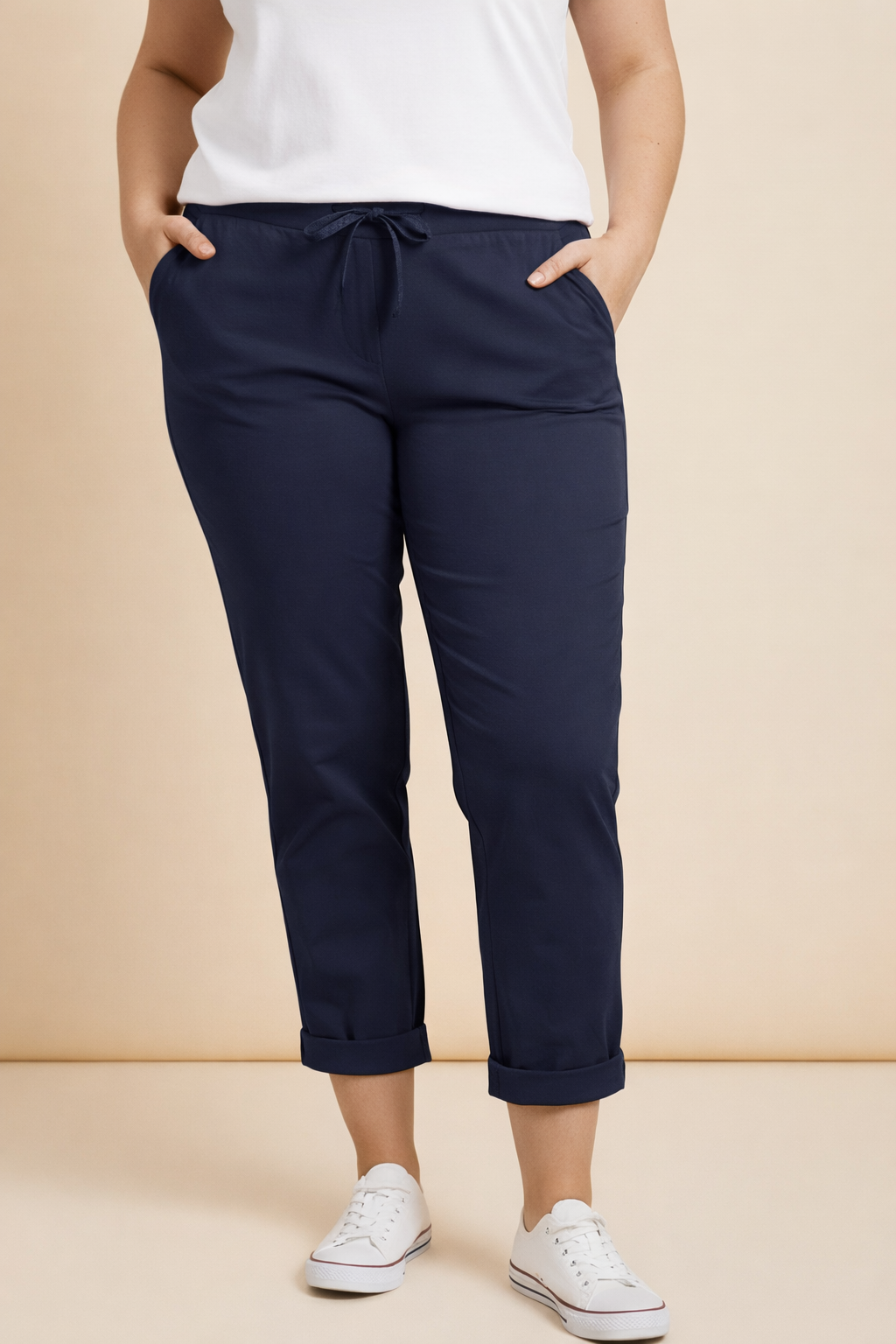 Navy jogger bottoms, with White T-shirt and runners.