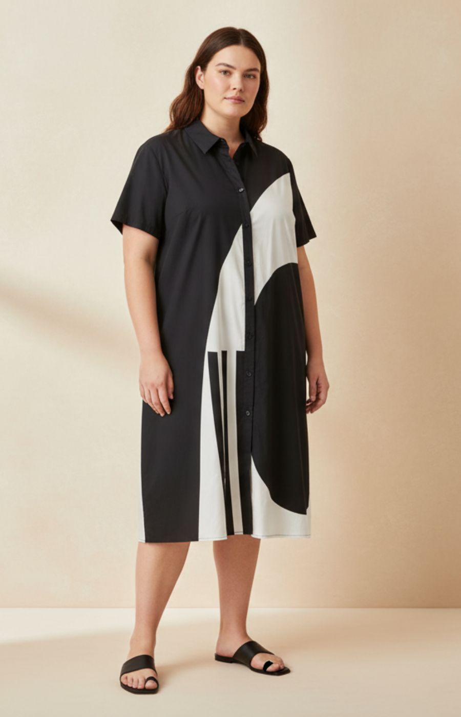 Gracie Dress in Black, A shirt dress with a button up front, round neckline with a shirt collar, short sleeves, side pockets, an A-line shape and a white design on the front