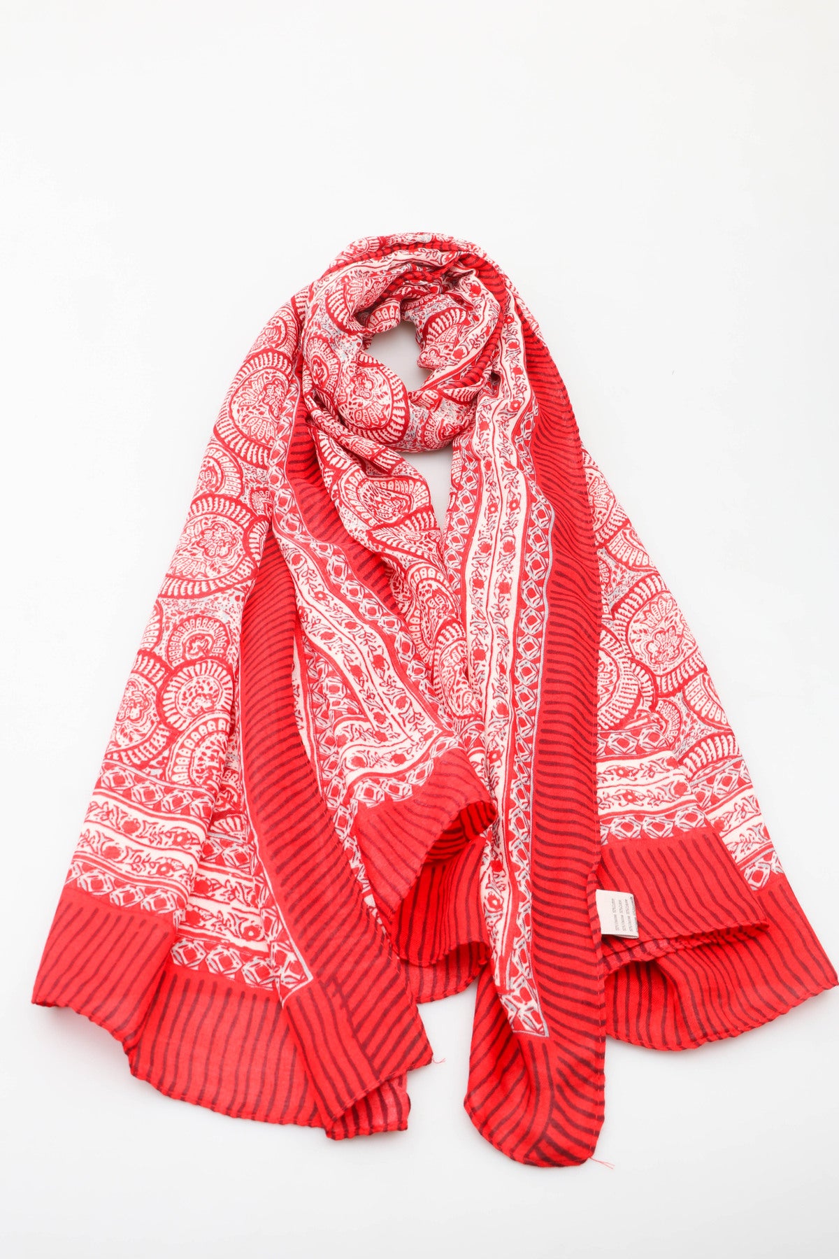Red scarf with white patterns on a white background