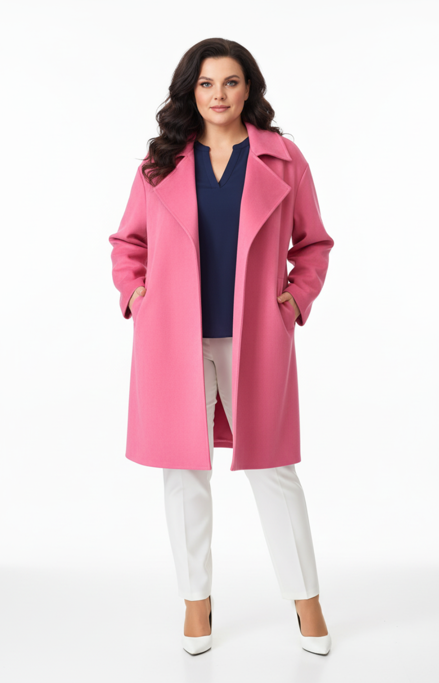 Woman wearing a pink coat over a navy top and white pants on a white background