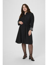 Woman wearing a black dress on a white background