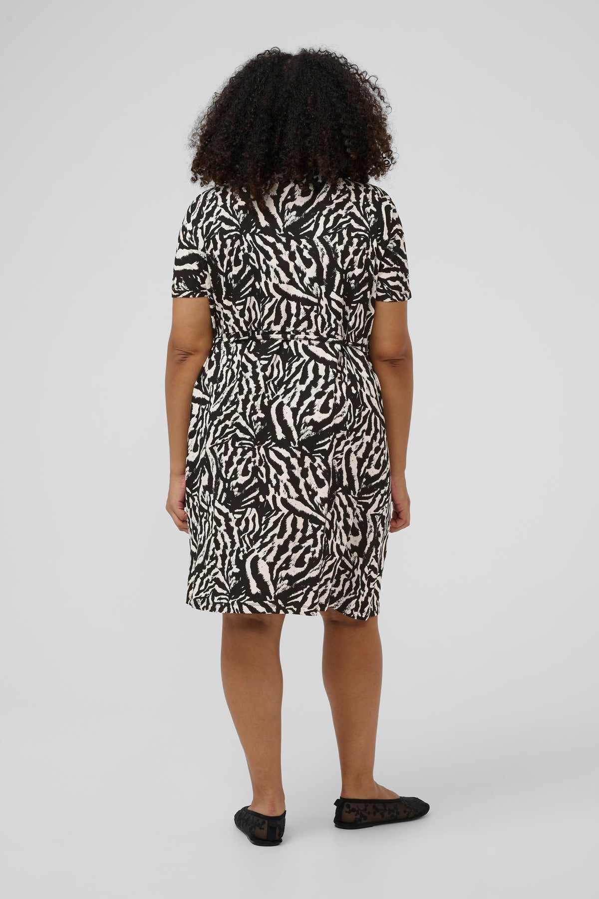 Knee length black and white animal print dress with short sleeves and a knee length