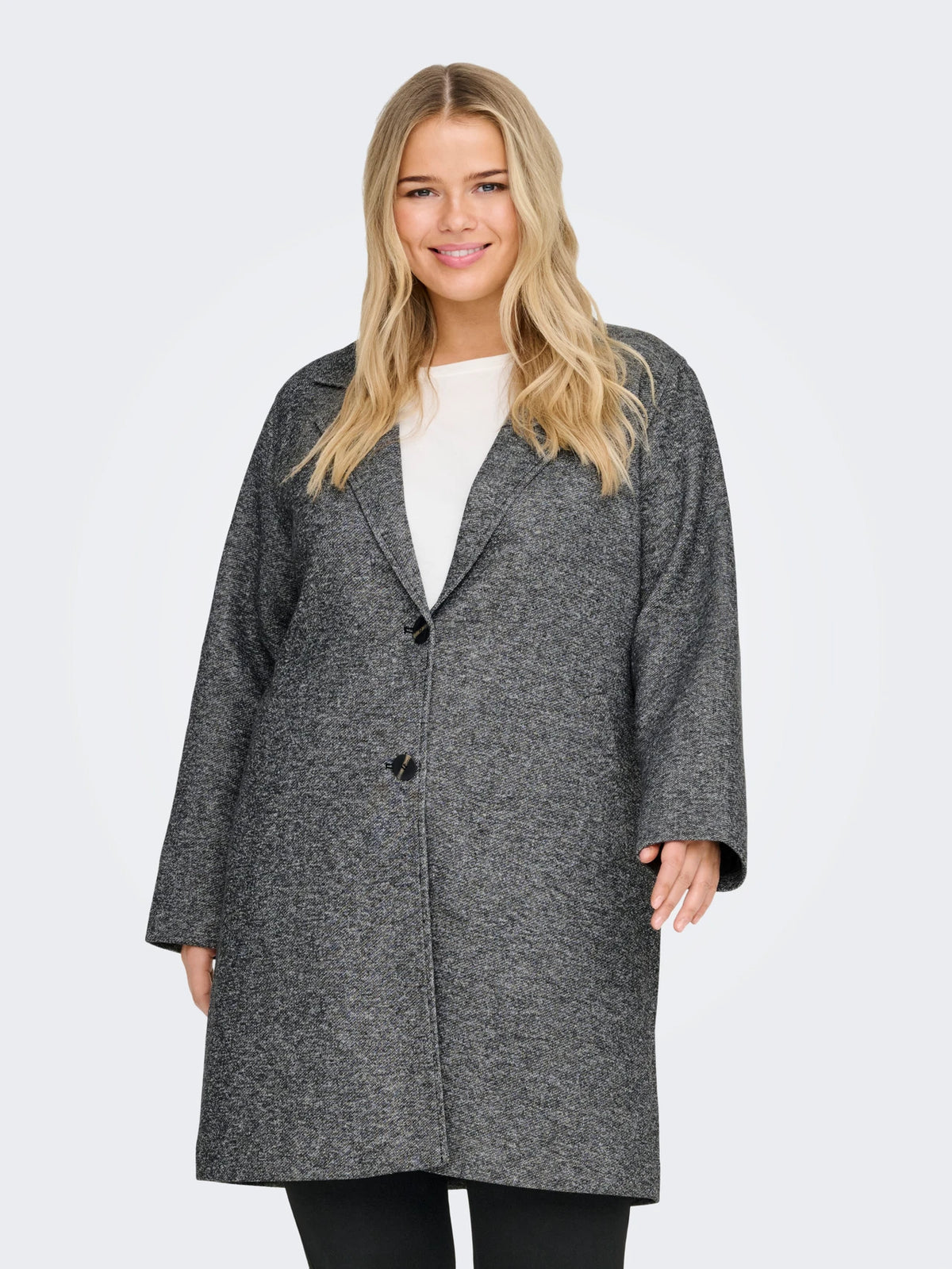 Woman wearing a gray coat on a light gray background