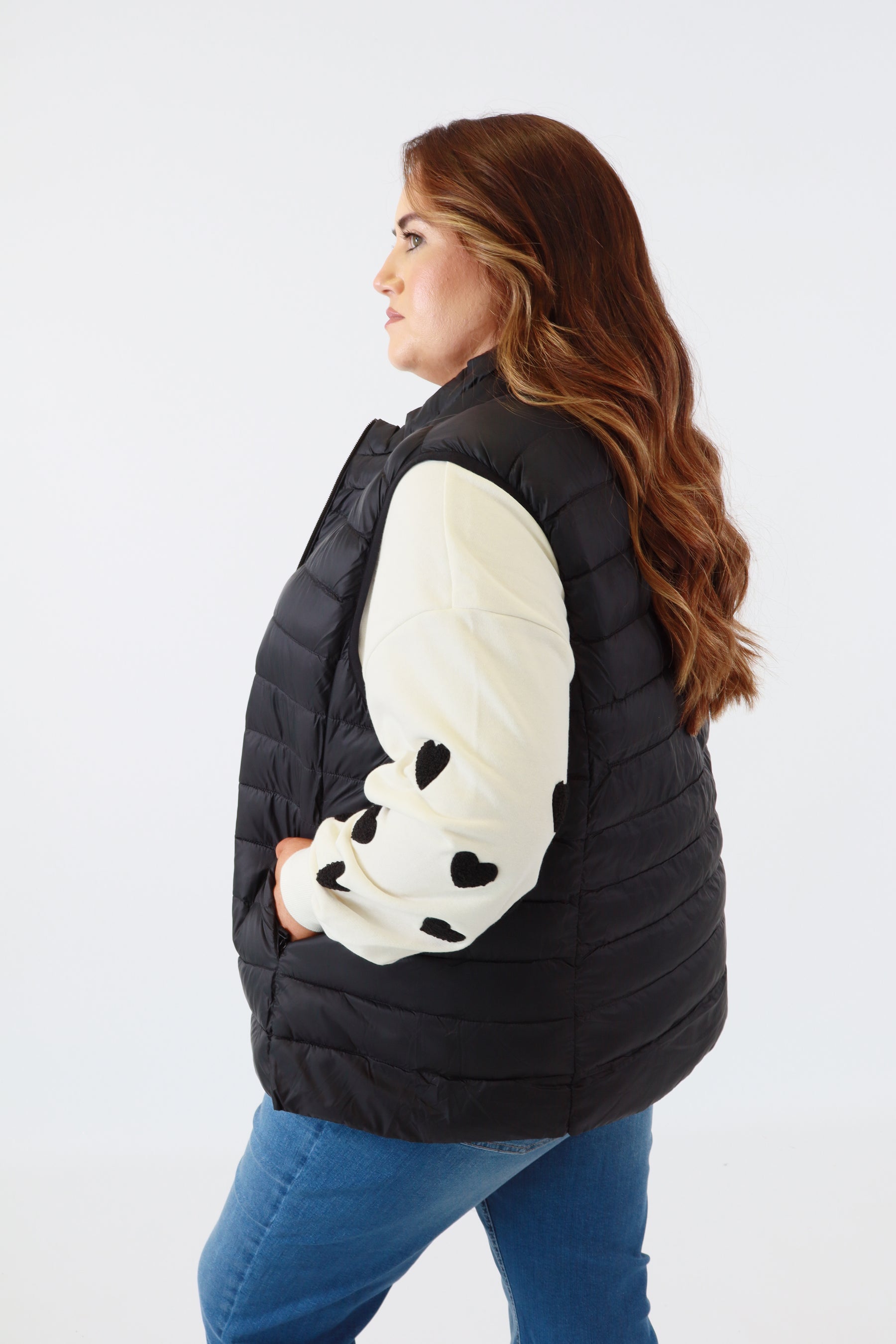 Person wearing a black vest with a panda design on a white background
