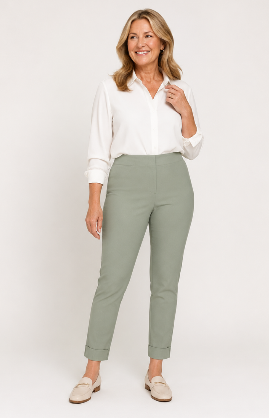 Woman wearing a white blouse and green pants on a white background