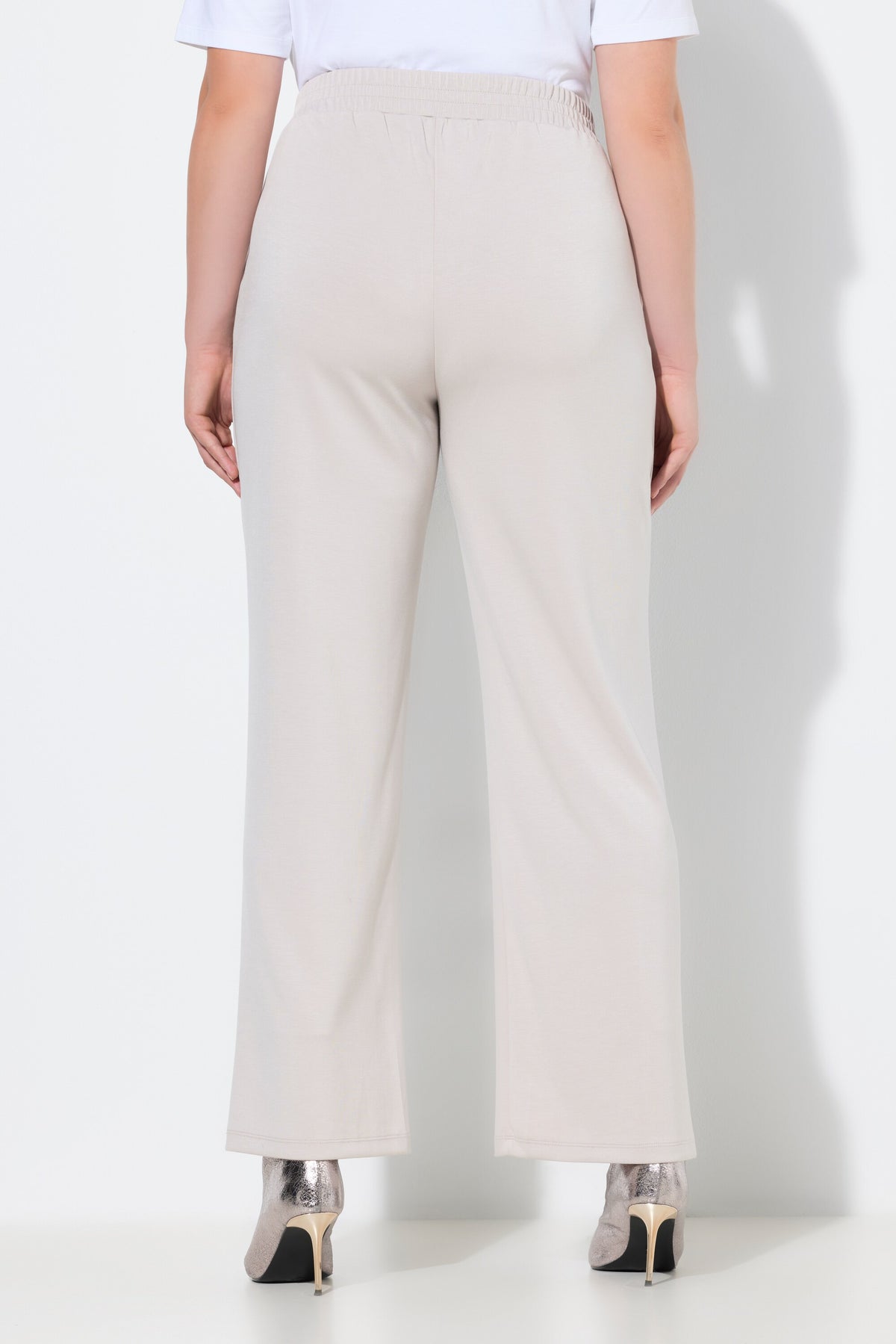 Women wearing the Ulla Popken Wide Leg Trouser in Beige, a wide leg trouser with an elasticated waistband, side pockets and piping down the front