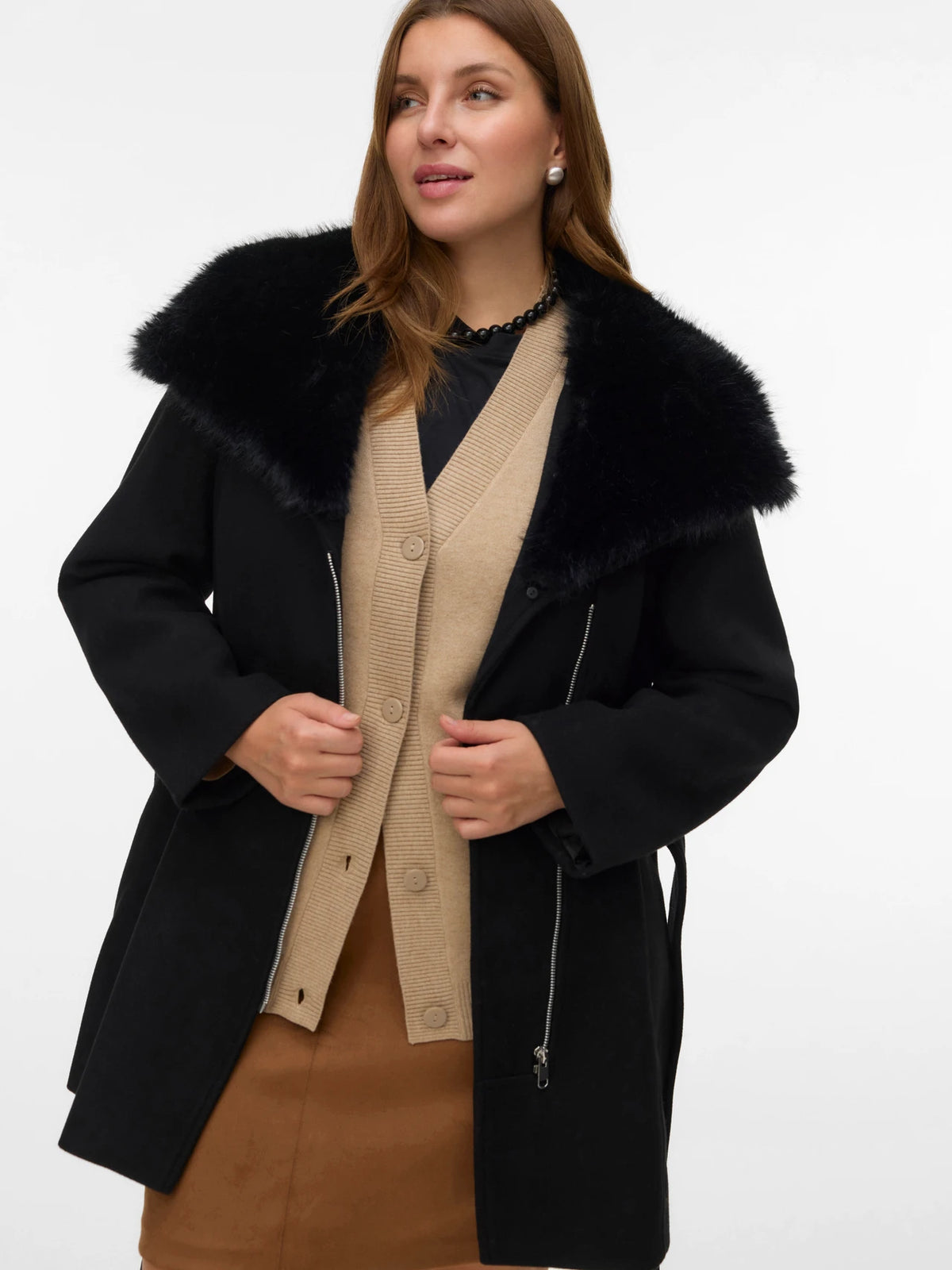 Woman wearing a black coat with a fur collar on a white background