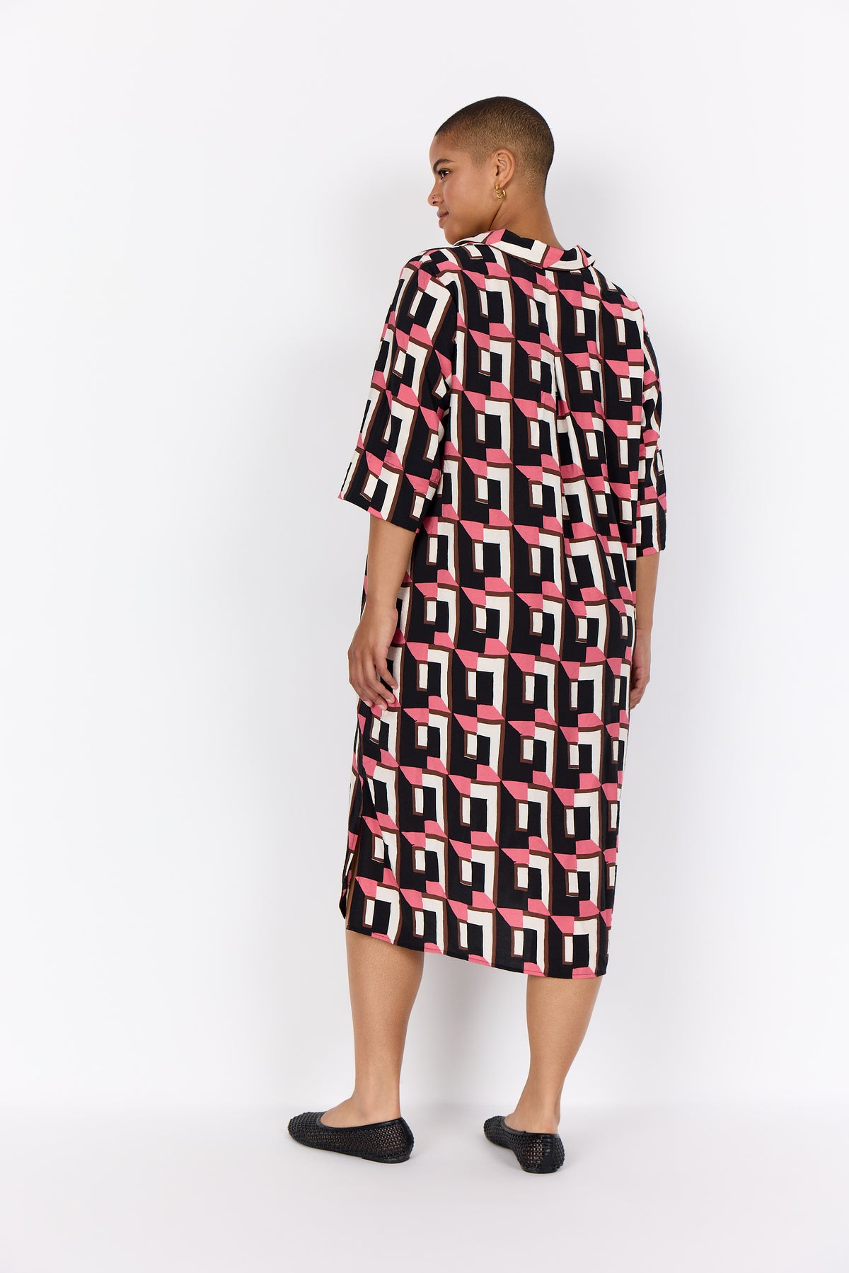 Person wearing Wasabi Sarena Dress in Pink with a white background, a midi length dress with 1/2 sleeves