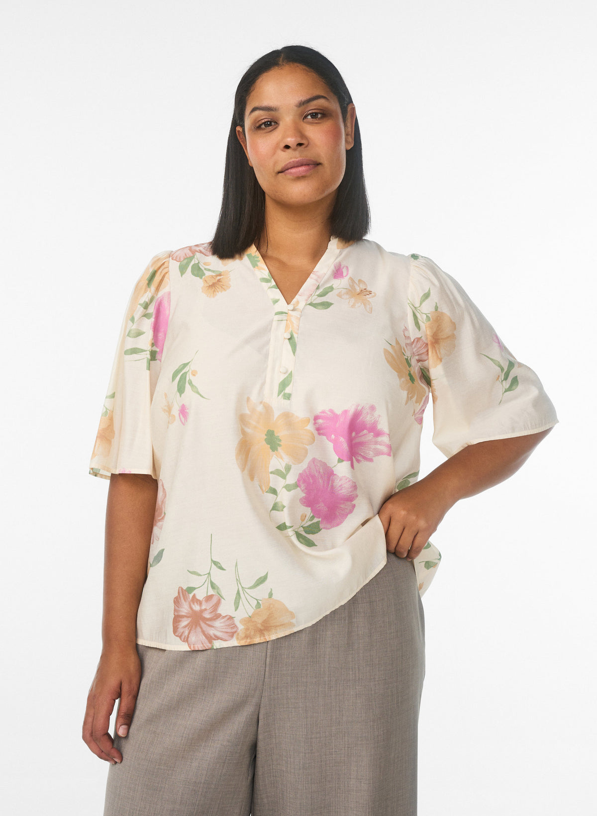 Woman wearing a floral blouse with a plain background