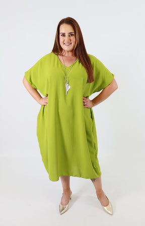 Woman wearing a green dress on a white background