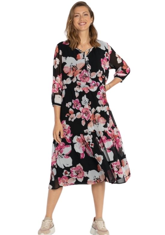A woman standing up wearing Via Appia Black floral dress