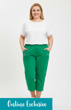 Woman wearing a white top and green pants on a white background with 'Online Exclusive' text.