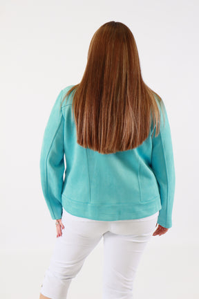 Person wearing a turquoise scarf on a white background
