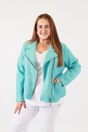 Woman wearing a turquoise jacket over a white shirt on a white background