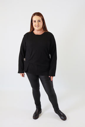 Person wearing a black outfit on a white background