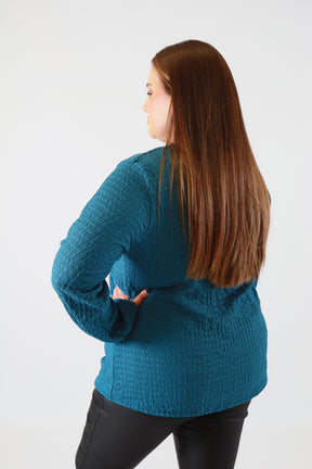 Person wearing a blue sweater on a white background