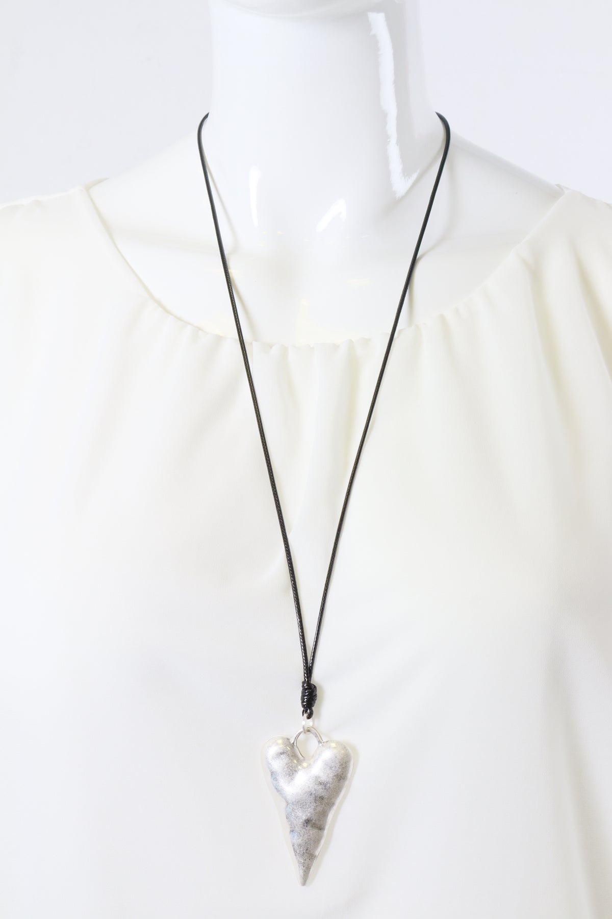 Necklace with a silver heart pendant on a white background
