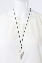 Necklace with a silver heart pendant on a white background