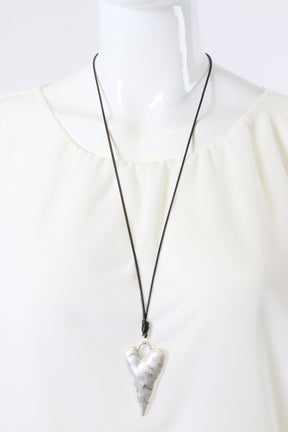 Necklace with a silver heart pendant on a white background