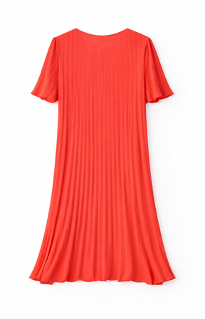 A coral pleated dress on a white background