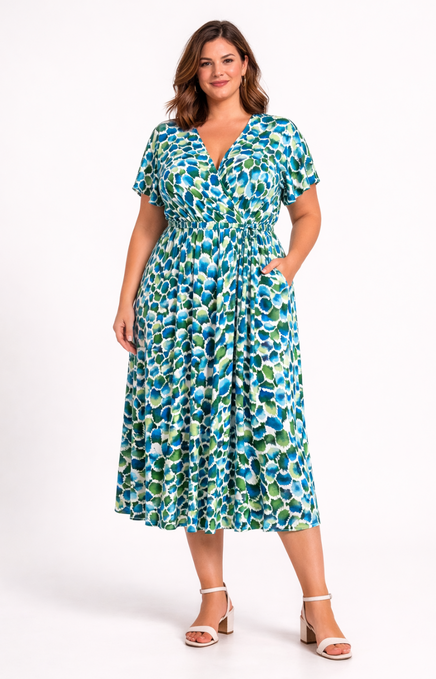 Woman wearing a blue and green patterned dress on a white background