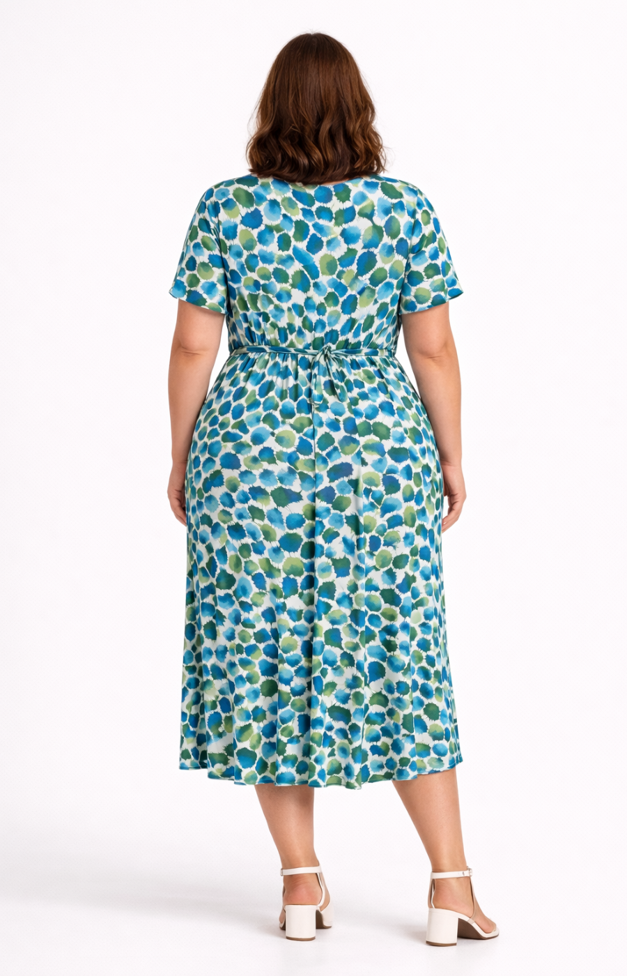 Woman wearing a blue and green patterned dress on a white background