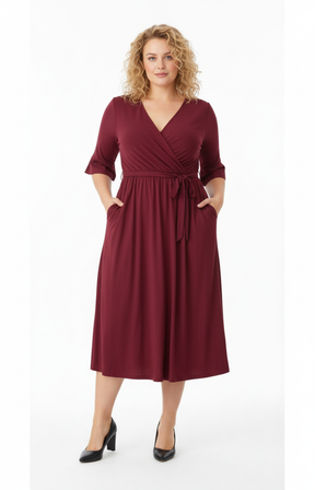 Woman wearing a burgundy dress with a white background