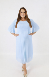 Woman wearing a light blue pleated dress on a white background 
