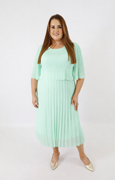 Woman wearing a light green dress on a white background