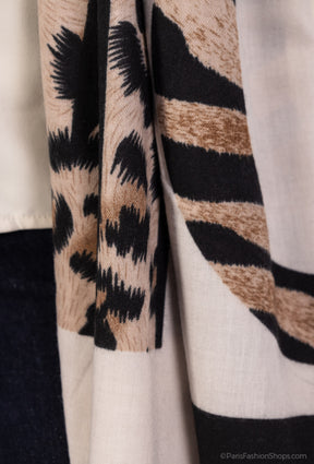 Close-up of a patterned fabric with black, brown, and beige colors.