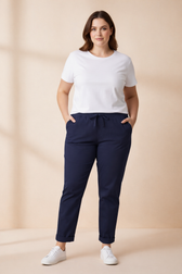 Woman wearing Navy jogger bottoms, with White T-shirt and runners.