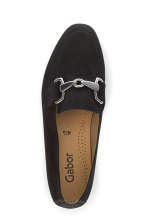 Black loafer shoe with a silver buckle on a white background 