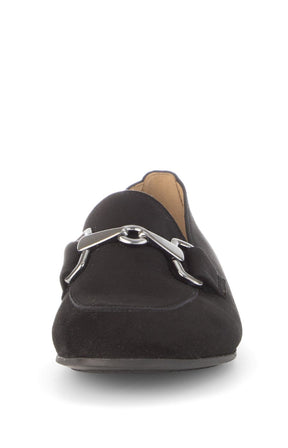 Black loafer shoe with a silver buckle on a white background 