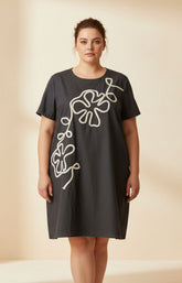Gabriela Dress in Black, A loose fit dress with an A-line shape, round neckline, short sleeves and a midi length. Also has an embroidered floral design on the front