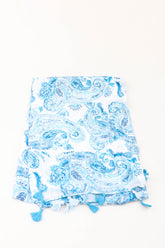 Blue and white paisley print scarf with tassels on a white background