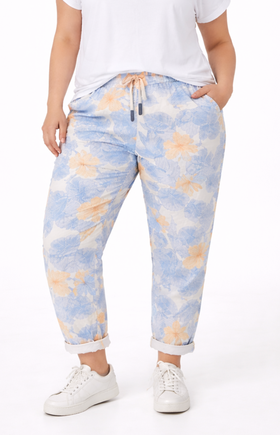 Person wearing blue and orange tie-dye pants on a white background
