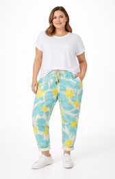 Woman wearing a white t-shirt and floral pants on a white background