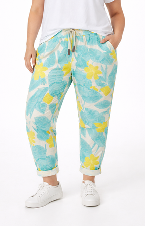 Person wearing floral-patterned pants on a white background